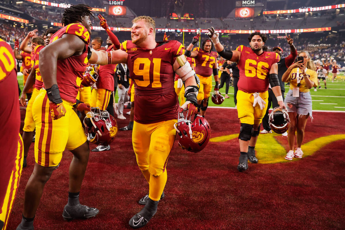 Southern California players celebrate winning the Vegas Kickoff Classic NCAA football game betw ...