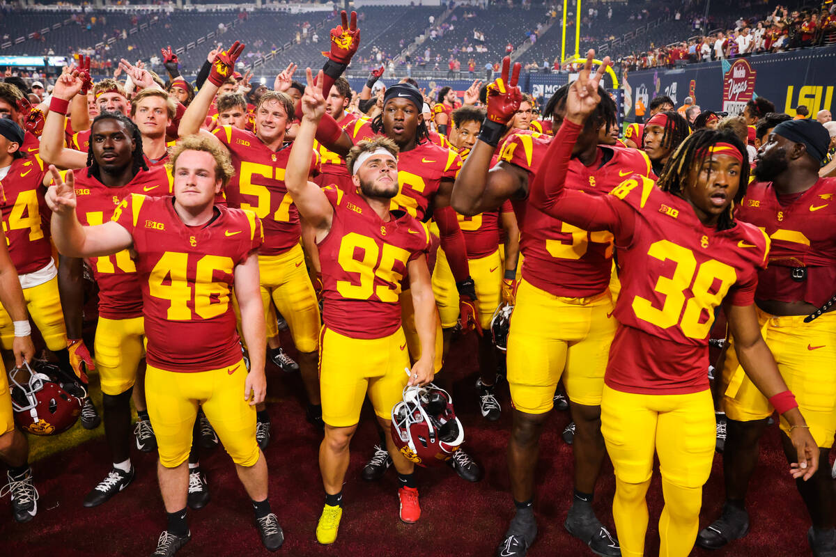 Southern California players celebrate winning the Vegas Kickoff Classic NCAA football game betw ...