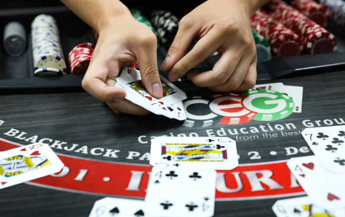 Marvin Ly practices dealing blackjack at the CEG Dealer School in Las Vegas in April 2021. (Rac ...