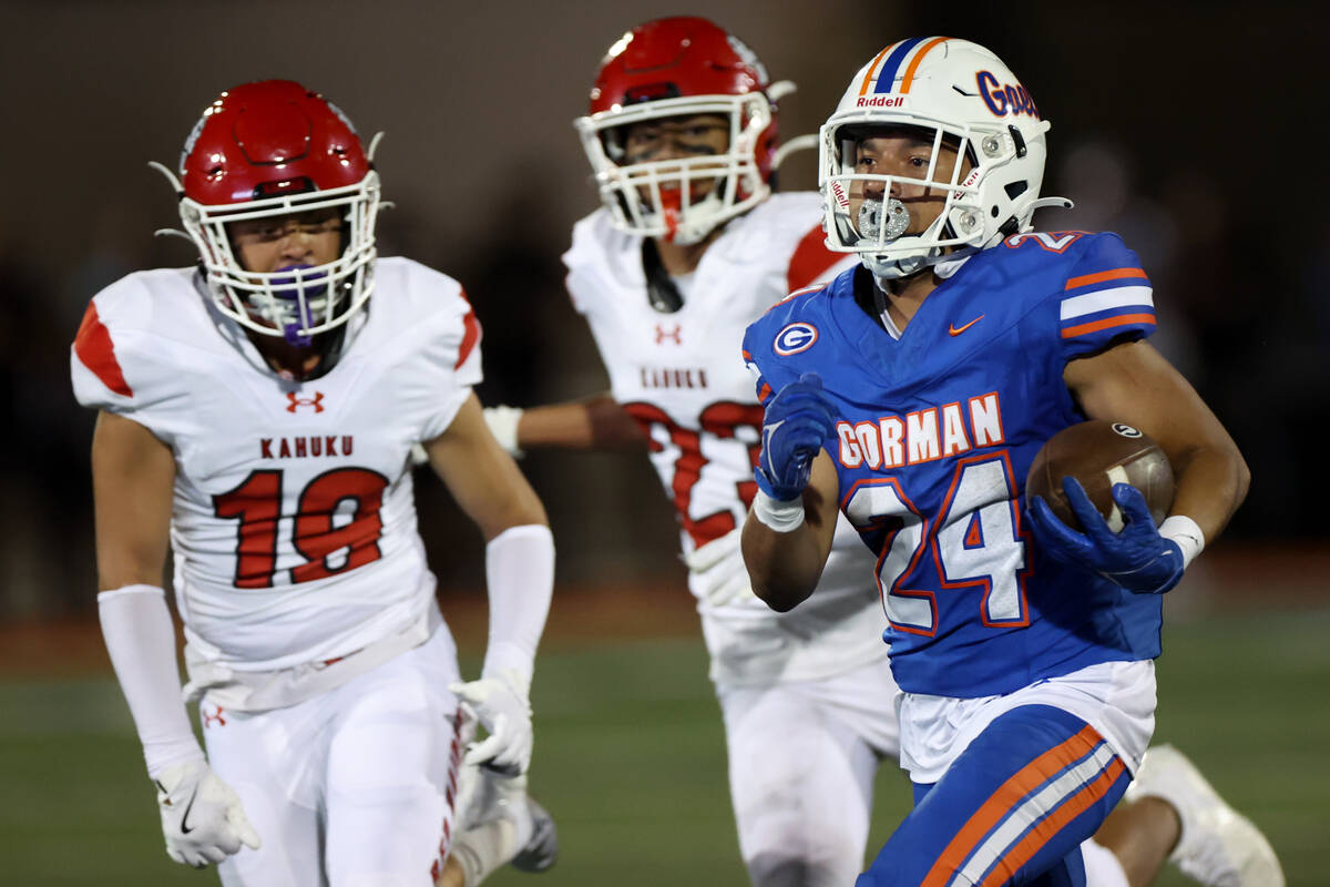 Bishop Gorman running back Myles Norman (24) carries the ball up the field while Kahuku defensi ...