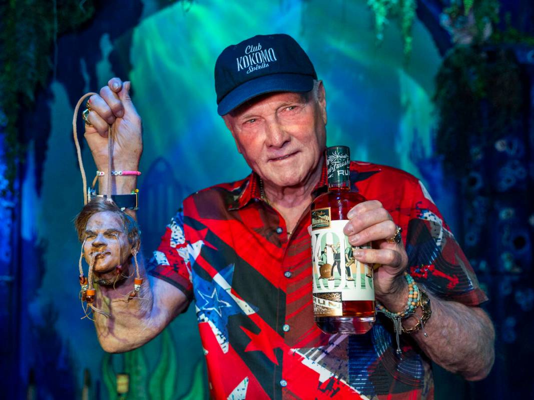 Beach Boys legend Mike Love holds his shrunken head and a bottle of his Club Kokomo Spirits rum ...