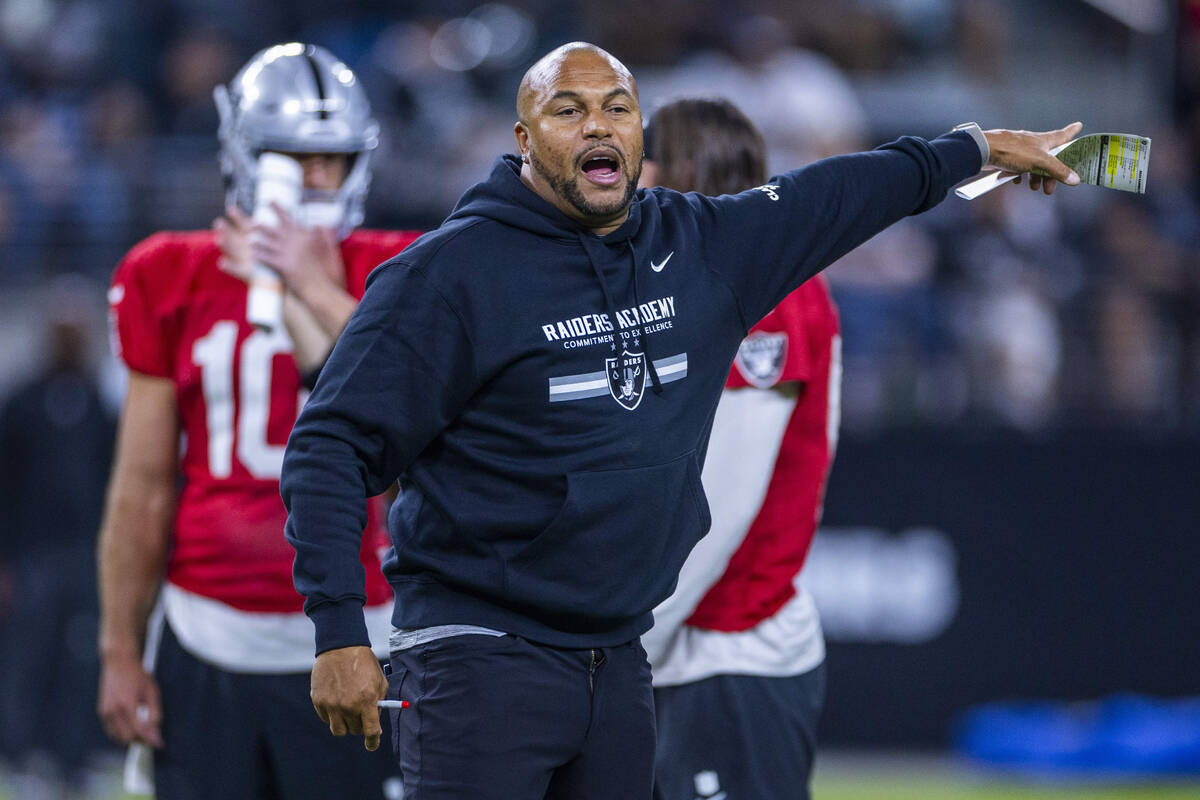 Raiders head coach Antonio Pierce directs players during an open practice at Allegiant Stadium ...