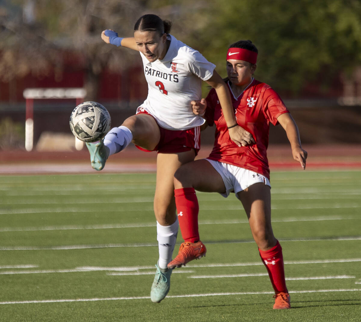 Liberty defender Rayen Garrett (3) and Arbor View sophomore Danielle Morales (3) compete for th ...