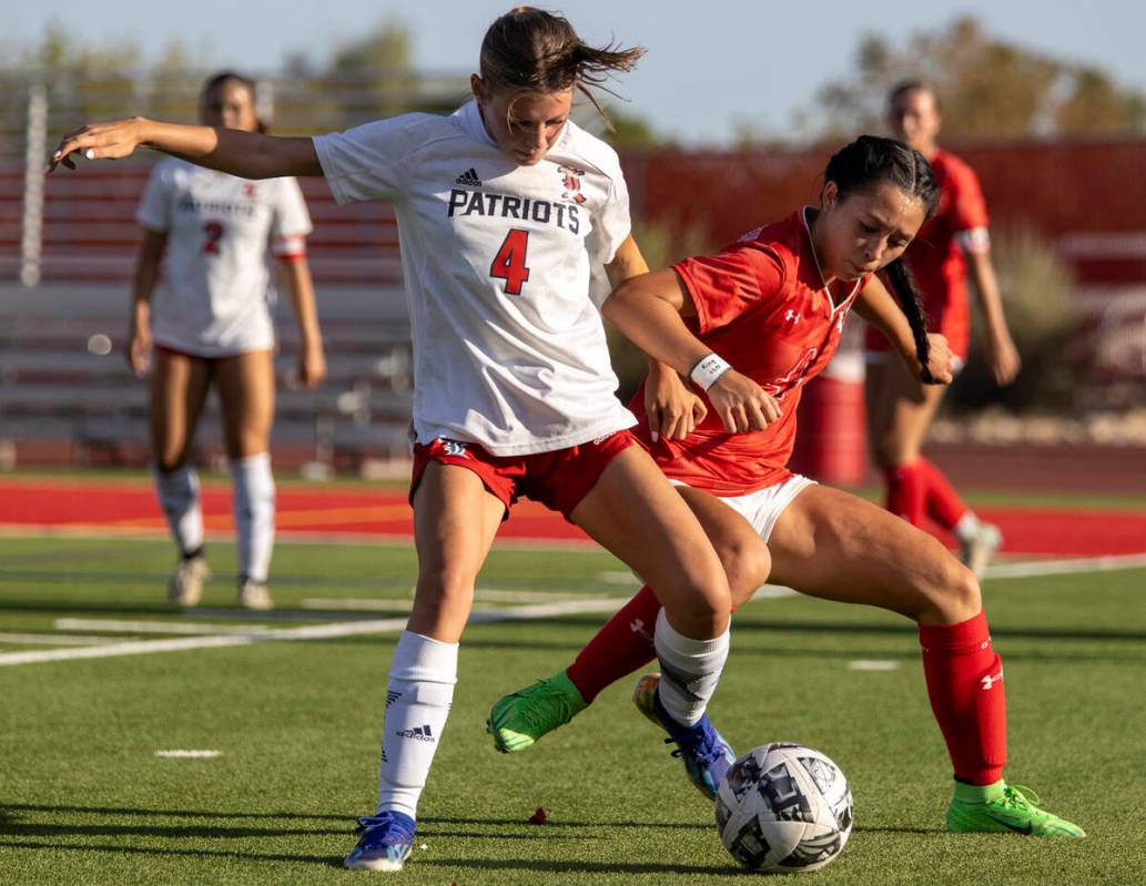 Liberty junior Lily Rothschild (4) and Arbor View sophomore Sophia Sachs (4) compete for the ba ...