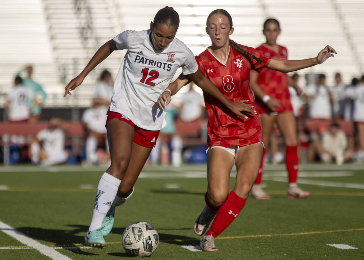 Liberty junior Ayva Jordan (12) and Arbor View sophomore Bailee Little (8) compete for the ball ...