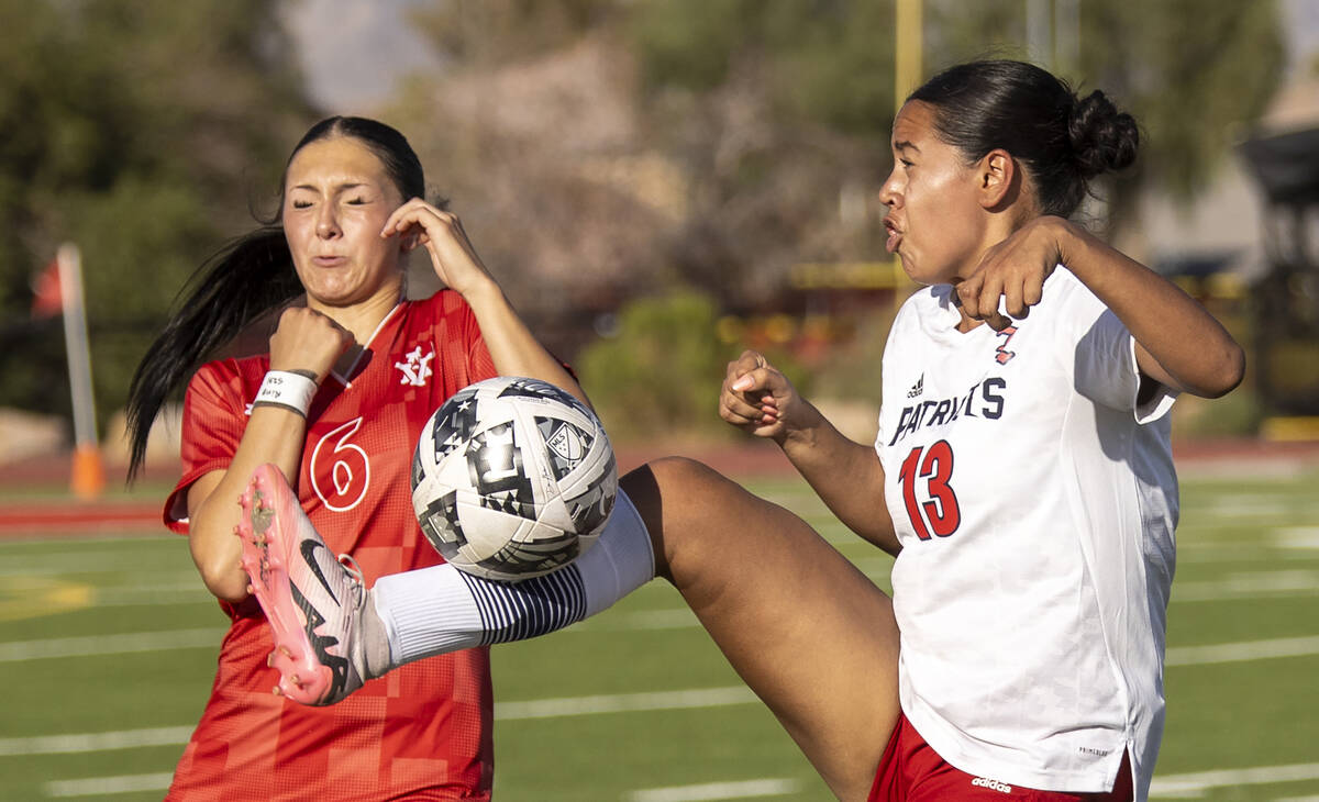 Arbor View sophomore Cadence Atkina (6) and Liberty senior Regina Cisneros (13) compete for the ...