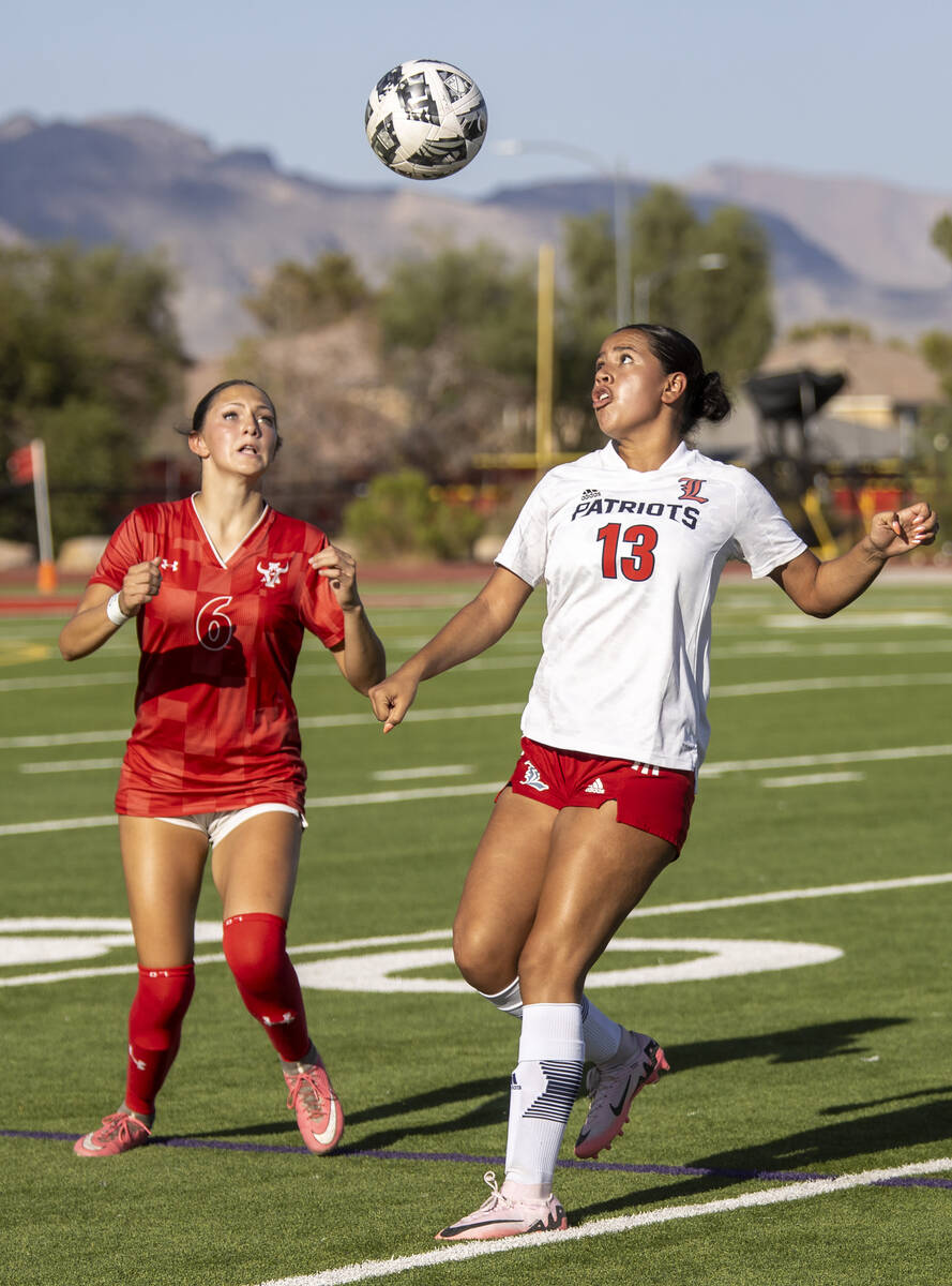 Arbor View sophomore Cadence Atkina (6) and Liberty senior Regina Cisneros (13) compete for the ...