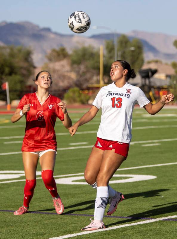 Arbor View sophomore Cadence Atkina (6) and Liberty senior Regina Cisneros (13) compete for the ...