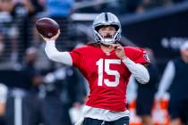 Raiders quarterback Gardner Minshew (15) looks to a receiver on a throw during an open practice ...