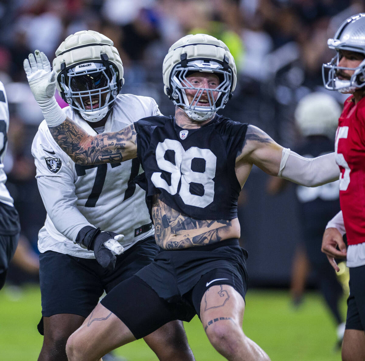 Raiders defensive end Maxx Crosby (98) gets past offensive tackle Thayer Munford Jr. (77) towar ...