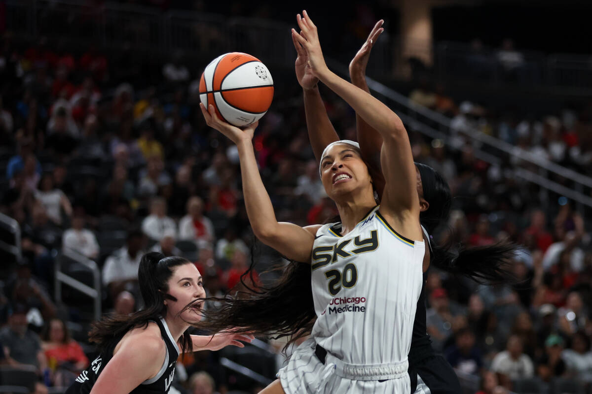 Chicago Sky forward Isabelle Harrison (20) shoots with pressure from Las Vegas Aces center Mega ...