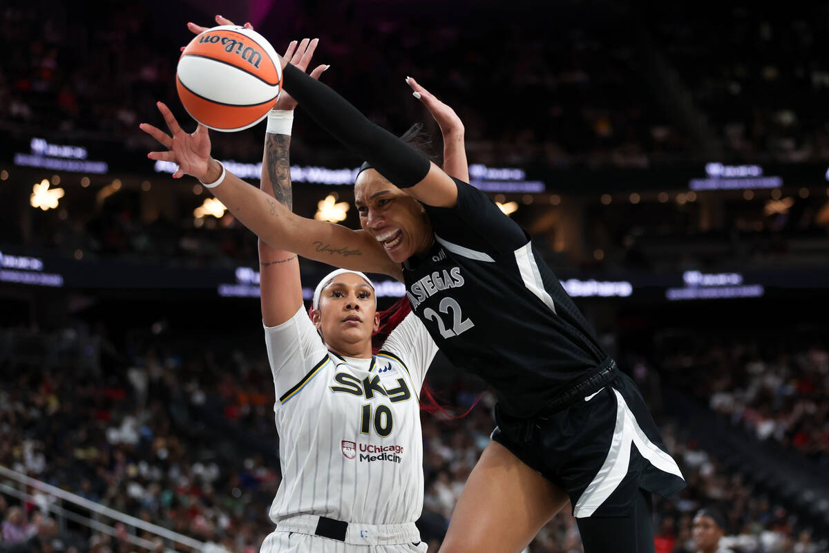 Las Vegas Aces center A'ja Wilson (22) falls while shooting as Chicago Sky center Kamilla Cardo ...