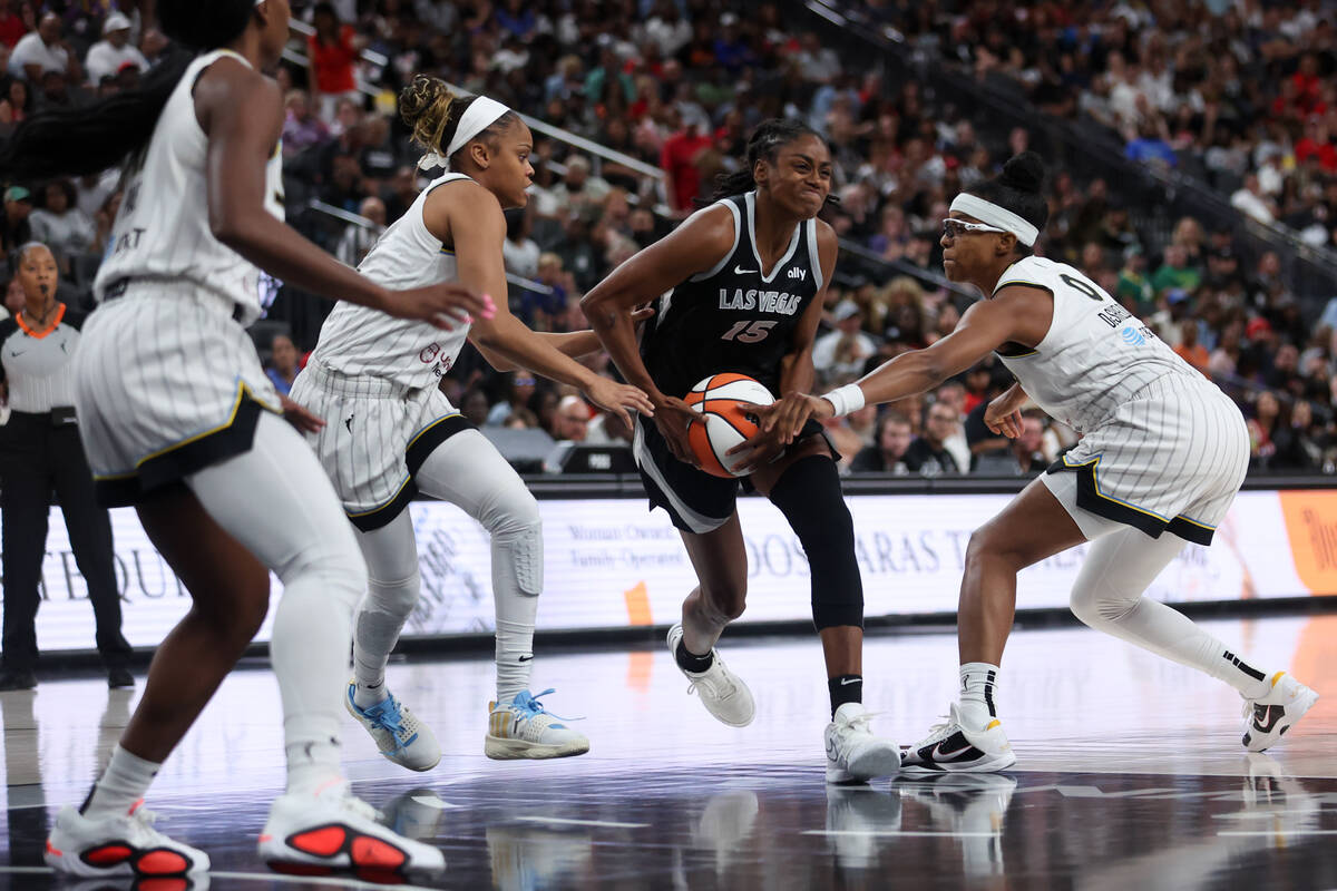 Las Vegas Aces guard Tiffany Hayes (15) drives between Chicago Sky guard Moriah Jefferson, left ...