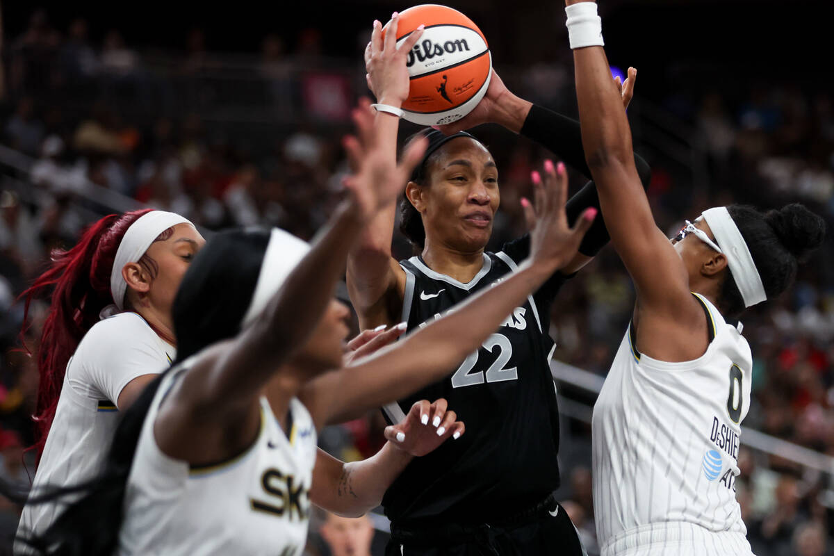 Las Vegas Aces center A'ja Wilson (22) looks to pass while the Chicago Sky surround her during ...