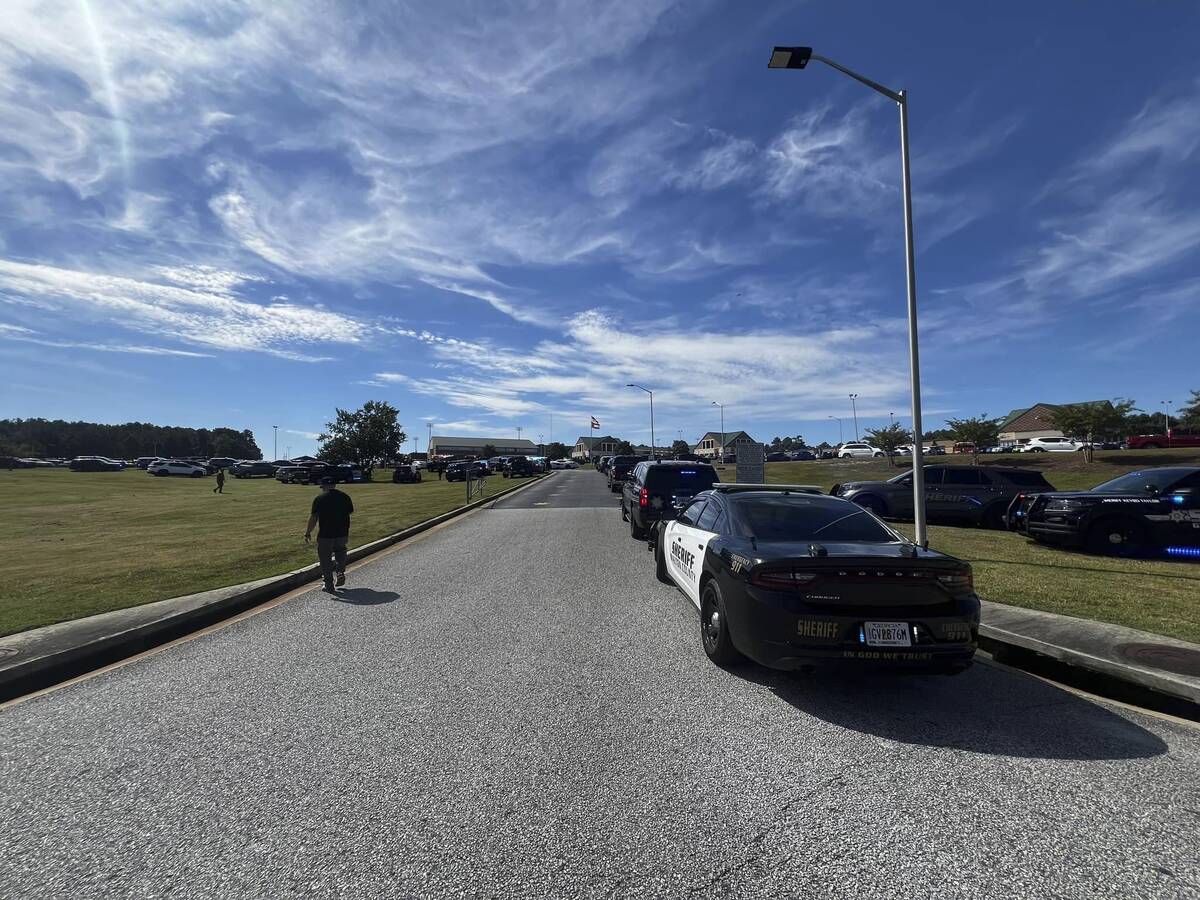 Law enforcement arrive as students are evacuated to the football stadium after the school campu ...