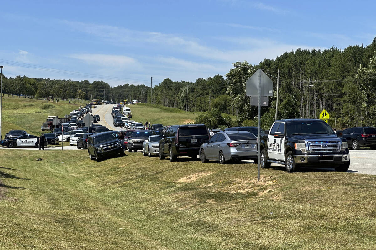 Law enforcement arrive as students are evacuated to the football stadium after the school campu ...