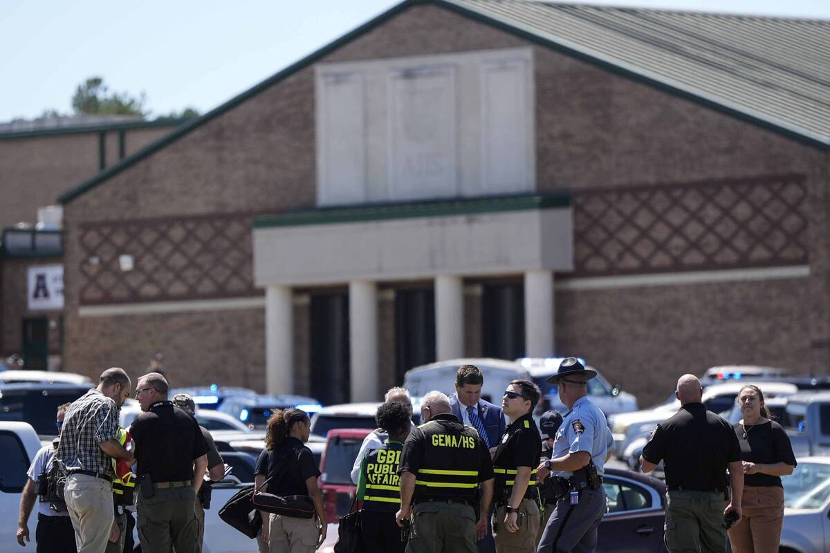 Police gather outside Apalachee High School after a shooting at the school Wednesday, Sept. 4, ...