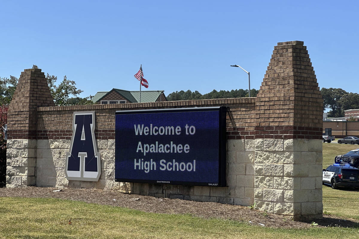 Law enforcement arrive as students are evacuated to the football stadium after the school campu ...