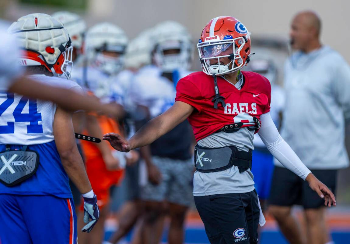 Bishop Gorman quarterback Melvin Spicer IV (#2) talks to running back Myles Norman (24) during ...