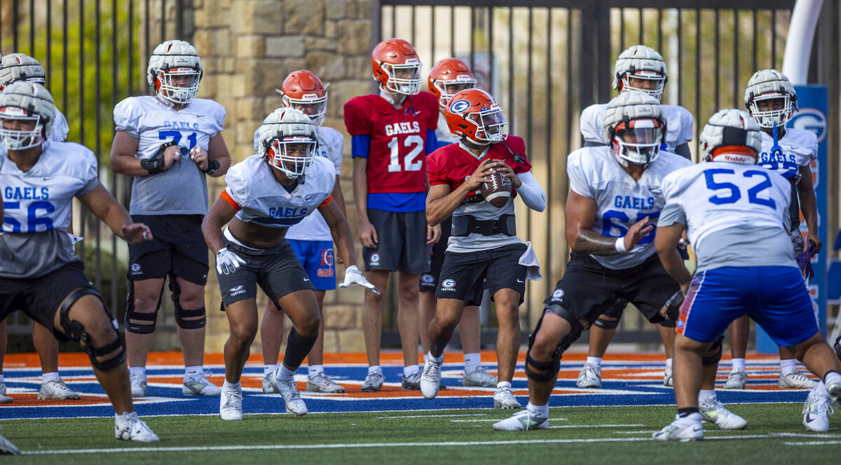 Bishop Gorman quarterback Melvin Spicer IV (#2) steps back in the pocket during football practi ...