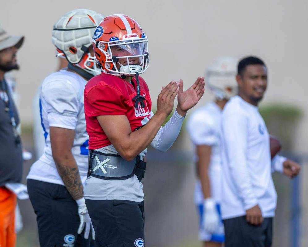 Bishop Gorman quarterback Melvin Spicer IV (#2) applauds a great catch during football practice ...