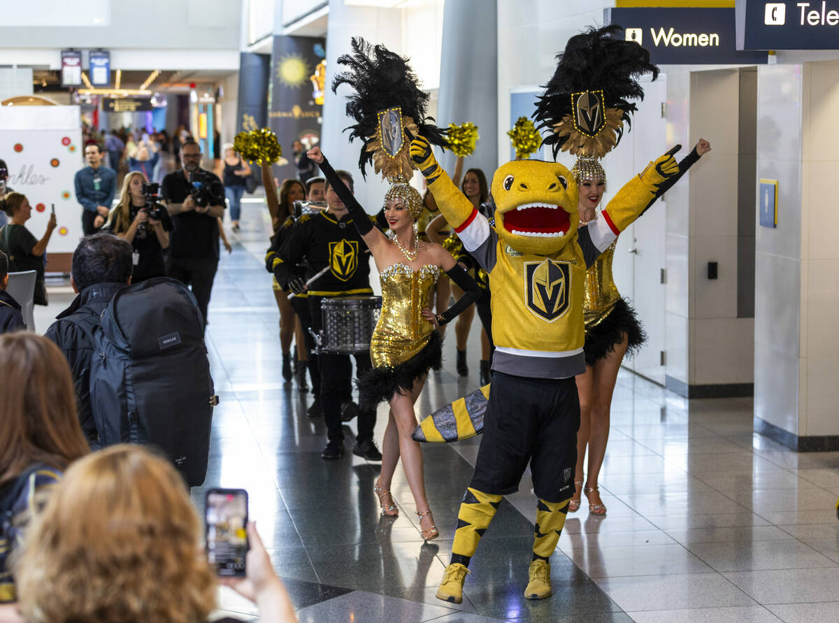 Golden Knights Mascot Chance leads a processional of showgirls, the Drumbeats and cheerleaders ...