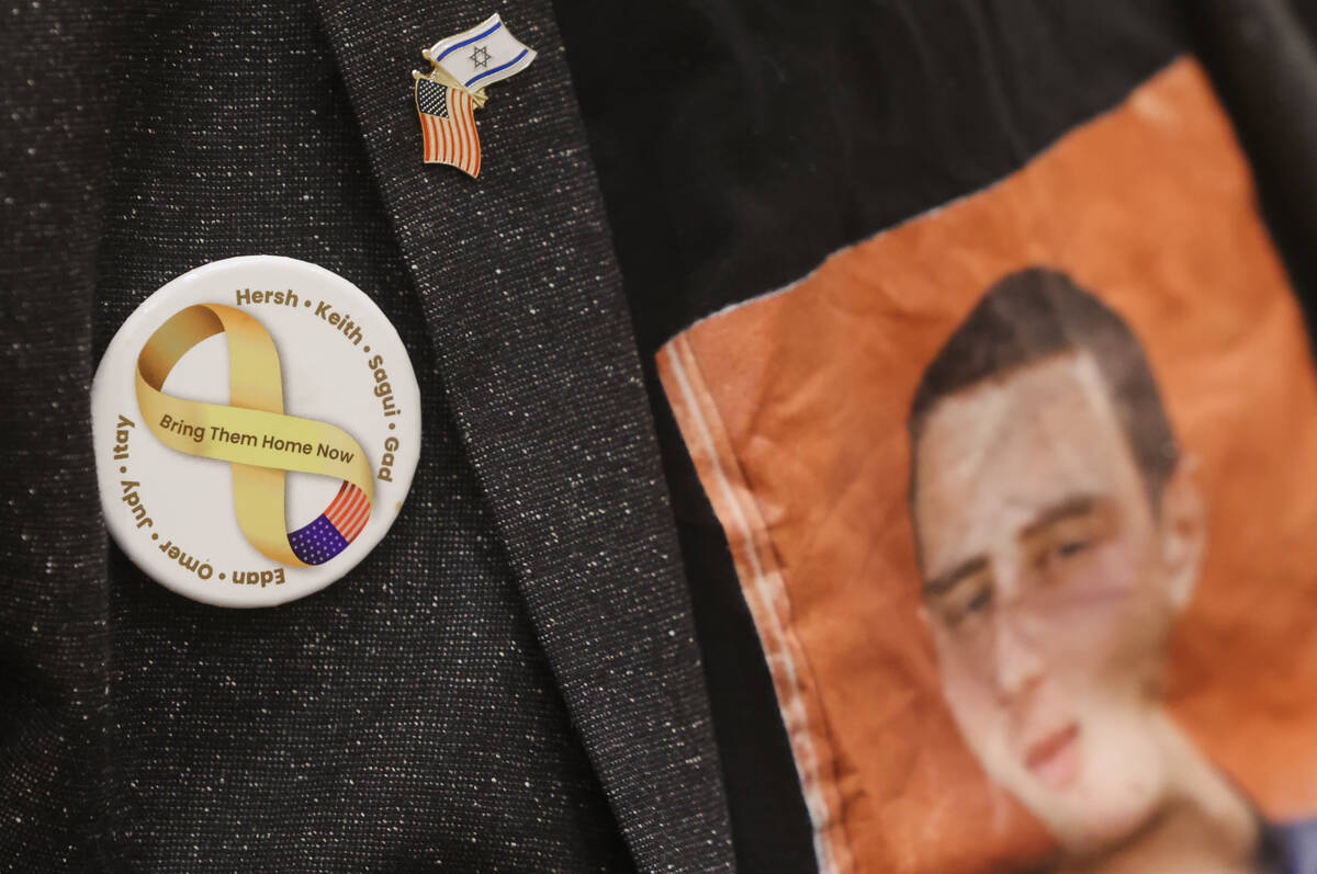 Ronen Neutra wears a button in honor of eight individuals, including his son, Omer, who have be ...