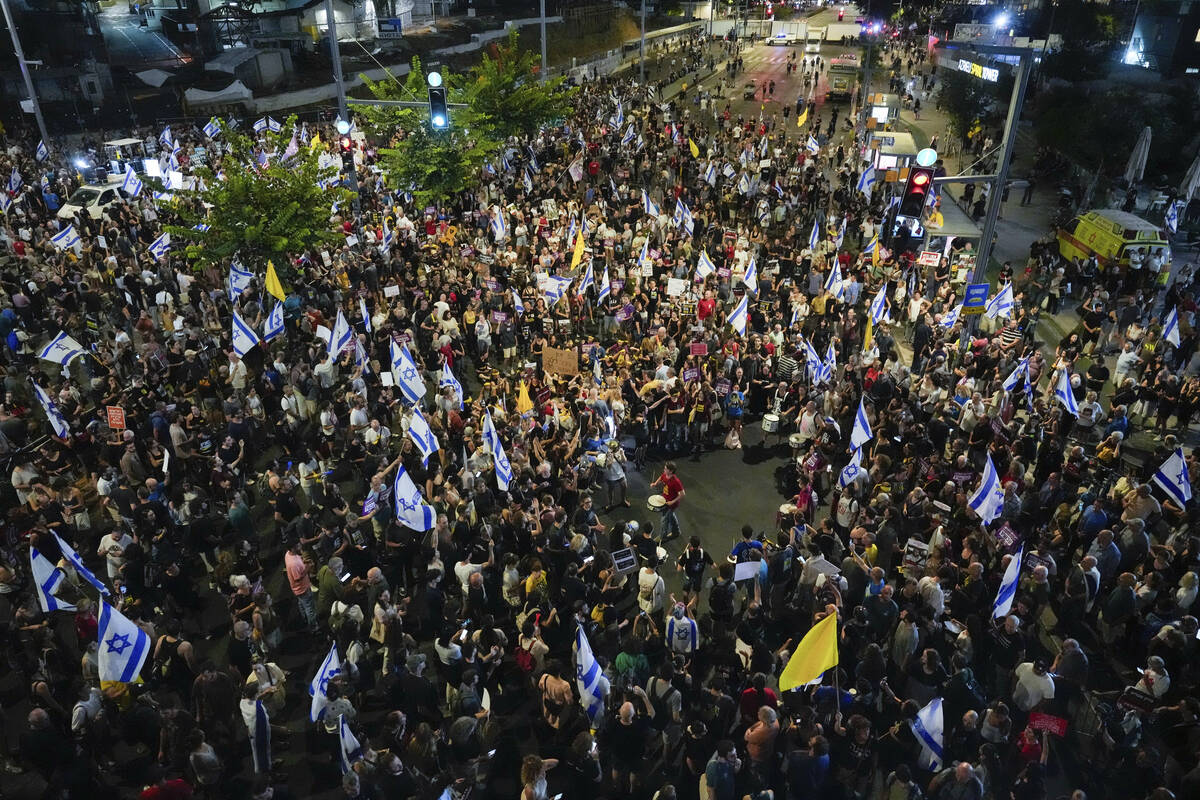 People attend a rally demanding a cease-fire deal and the immediate release of hostages held by ...