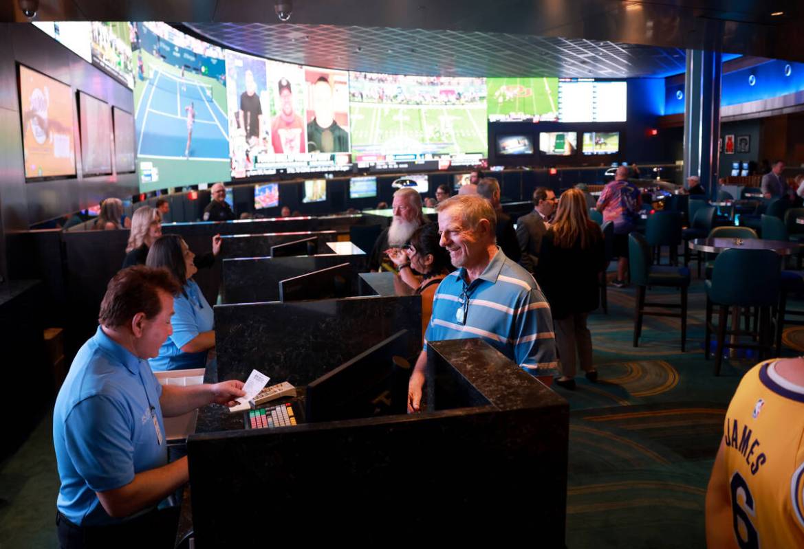 Phil Newell of Las Vegas, right, places a bet with Vincent Cervoni at the new Suncoast sportsbo ...