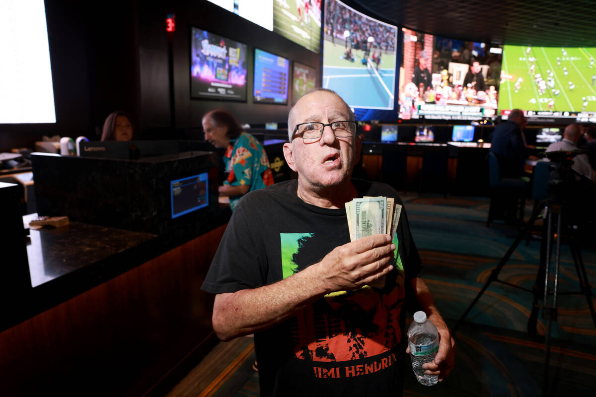 Mike Monteiro of Las Vegas shows his winnings at the new Suncoast sportsbook in Las Vegas Wedne ...