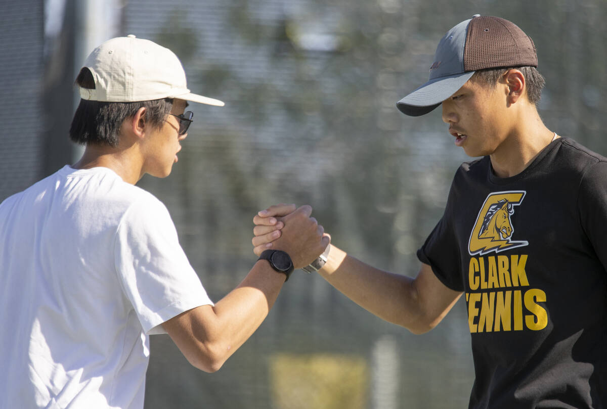 Clark sophomore Tristan Trinh, left, and senior Jayden Hong, right, celebrate during the high s ...