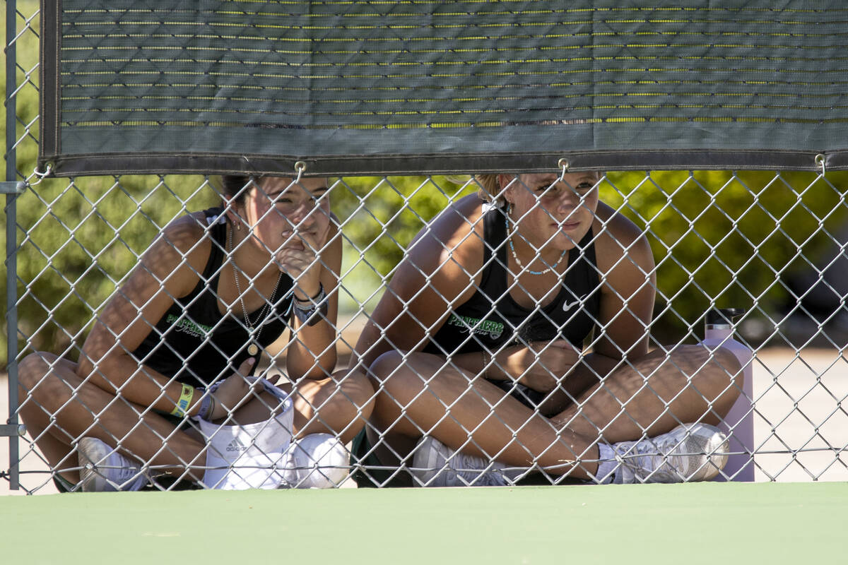 Palo Verde players watch their teammates in the shade during the high school tennis matches aga ...