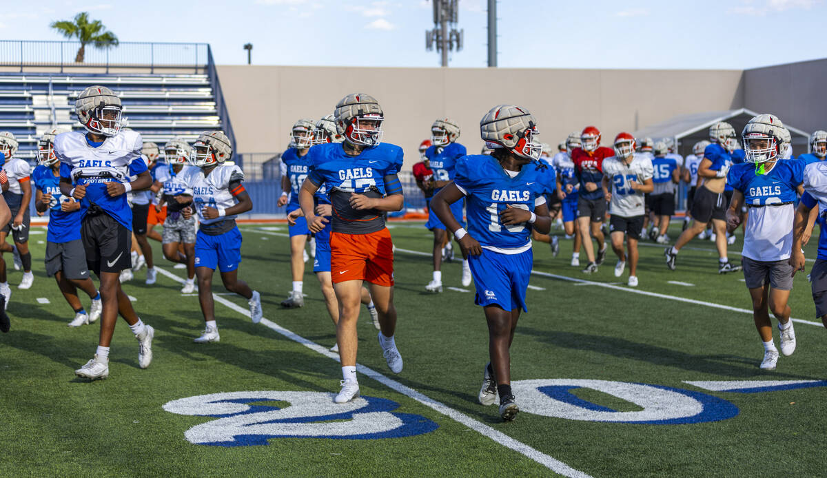 Players run on the field during Bishop Gorman football practice on Tuesday, Sept. 03, 2024, in ...