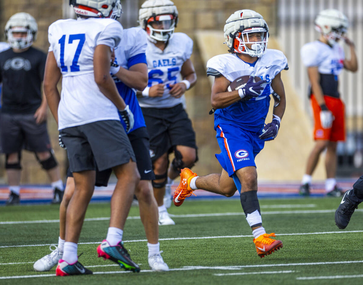 Bishop Gorman running back Myles Norman (24) looks for daylight on a run during football practi ...