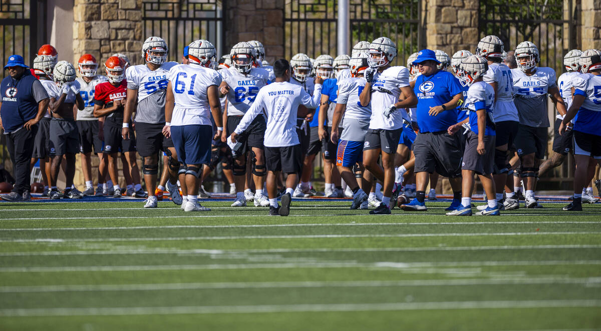 Bishop Gorman players gather on the field during football practice on Tuesday, Sept. 03, 2024, ...