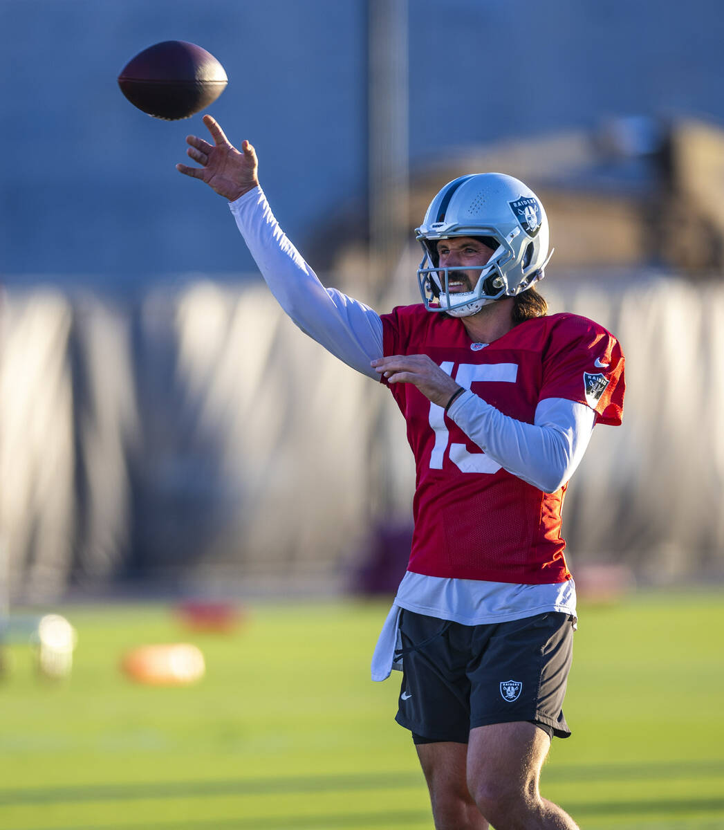 Raiders quarterback Gardner Minshew (15) gets off a pass during practice at the Intermountain H ...