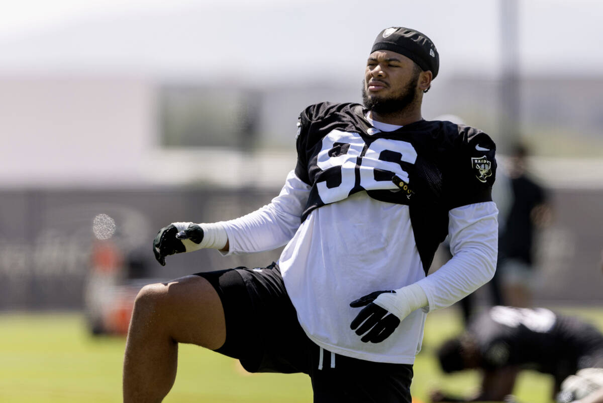 Raiders defensive tackle Jonah Laulu stretches during team practice at the Intermountain Health ...