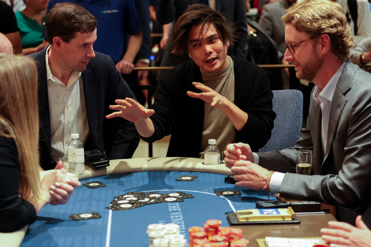 Magician Shin Lim, center, does a magic trick for Venetian CEO Patrick Nichols, right, and Vene ...