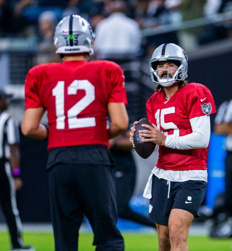 Raiders quarterback Gardner Minshew (15) chats with quarterback Aidan O'Connell (12) during an ...