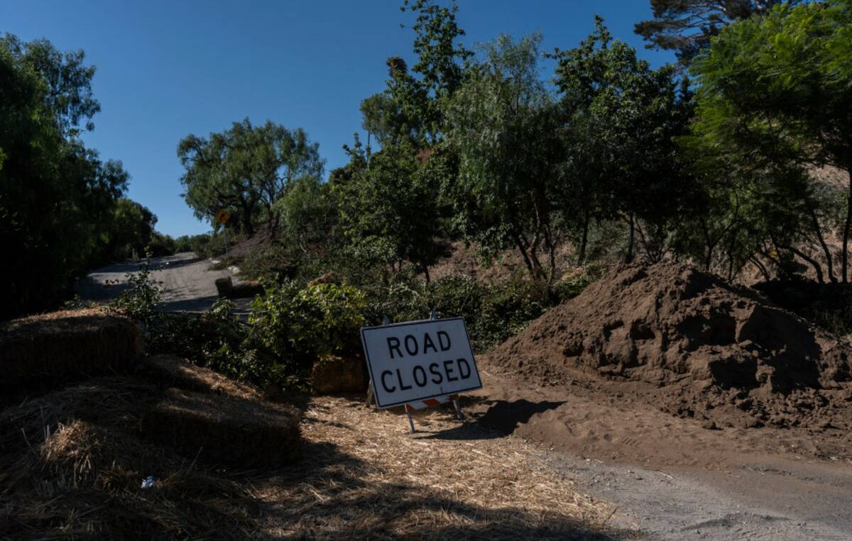 A road closure sign stands in a neighborhood affected by ongoing landslides in Rancho Palos Ver ...