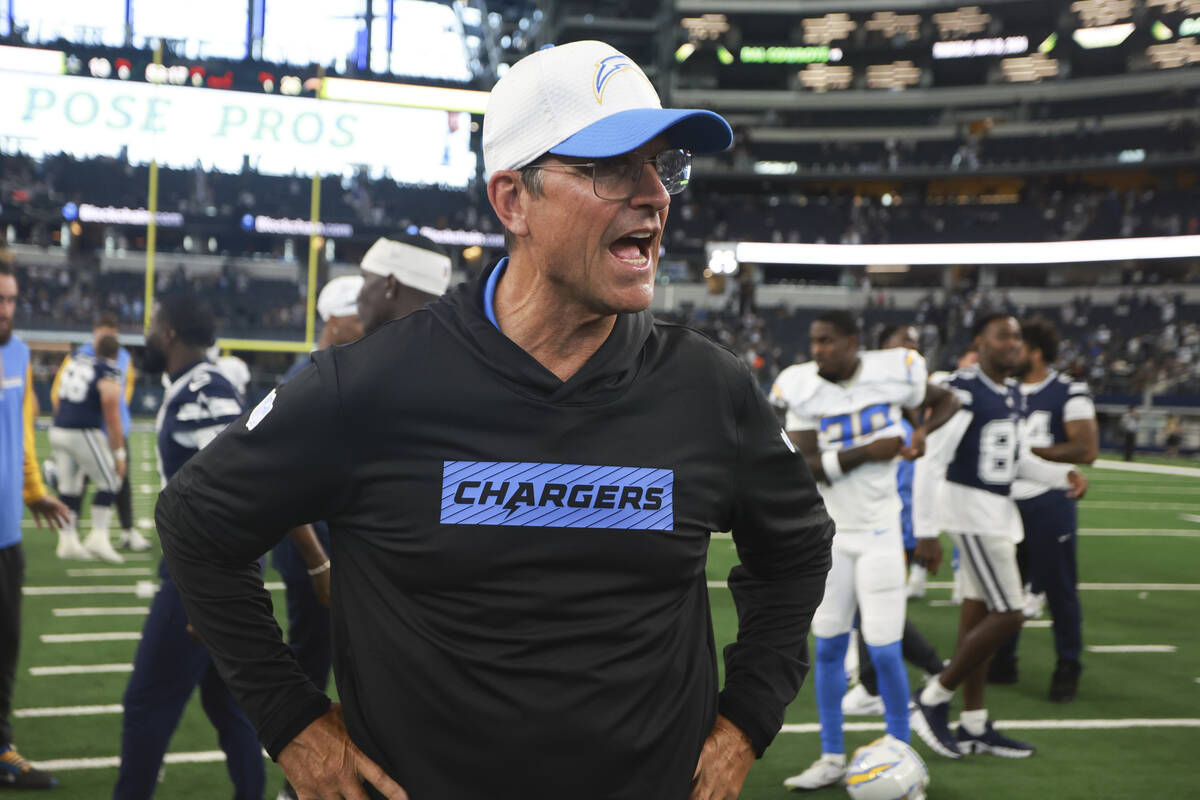 Los Angeles Chargers head coach Jim Harbaugh walks off the field after a preseason NFL football ...