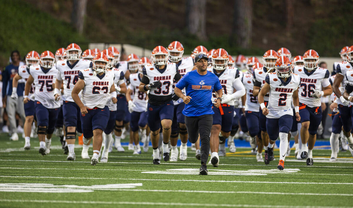 Bishop Gorman head coach Brent Browner leads his team onto the field to face Mater Dei during t ...