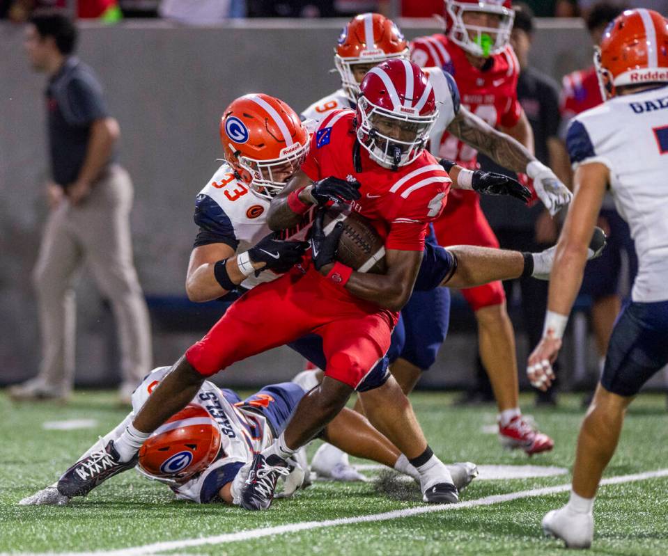 Bishop Gorman defensive lineman Ryan Baalbaky (33) catches Mater Dei wide receiver Kayden Dixon ...