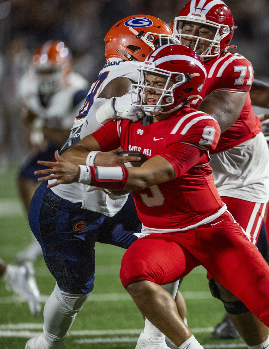 Bishop Gorman defensive lineman James Carrington (58) sacks Mater Dei quarterback Ashton Beier ...