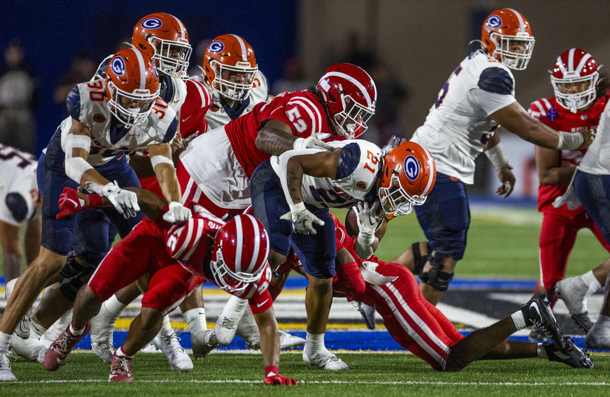 Bishop Gorman running back Jonathan Coar (21) battles for more yards against Mater Dei during t ...