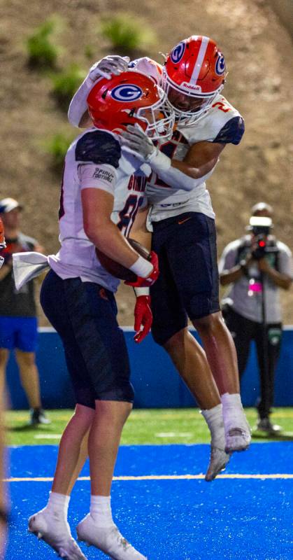 Bishop Gorman tight end Anthony Hickman (88) celebrates a touchdown catch with running back Jon ...