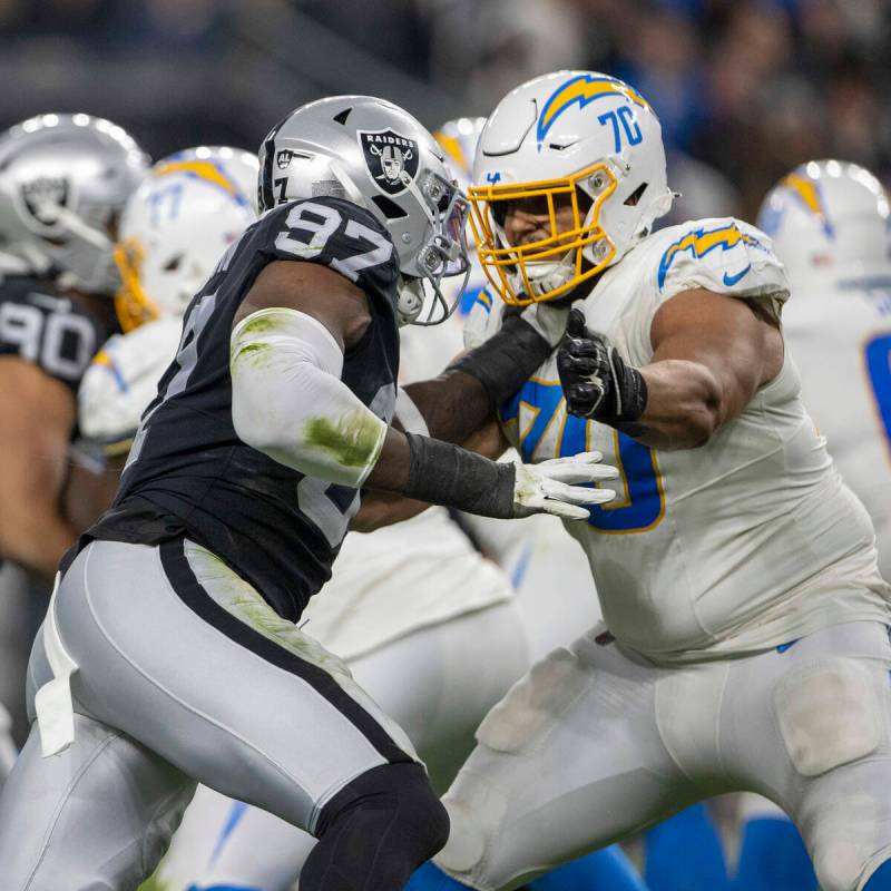 Raiders defensive end Janarius Robinson (97) defends against Los Angeles Chargers offensive tac ...