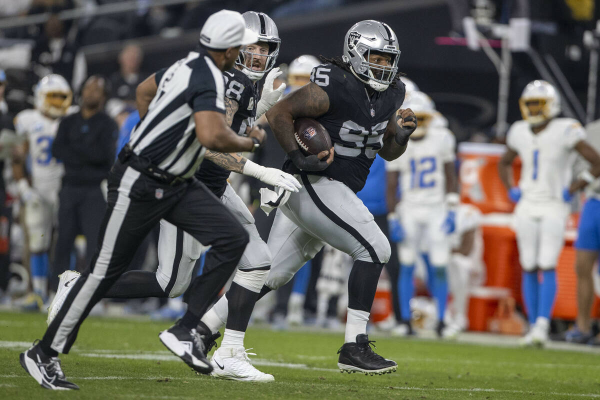 Raiders defensive tackle John Jenkins (95) runs with defensive end Maxx Crosby (98) after recov ...