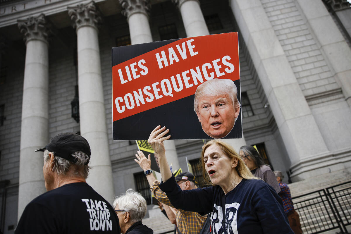 People protest against former President Donald Trump before his arrival to the New York Federal ...