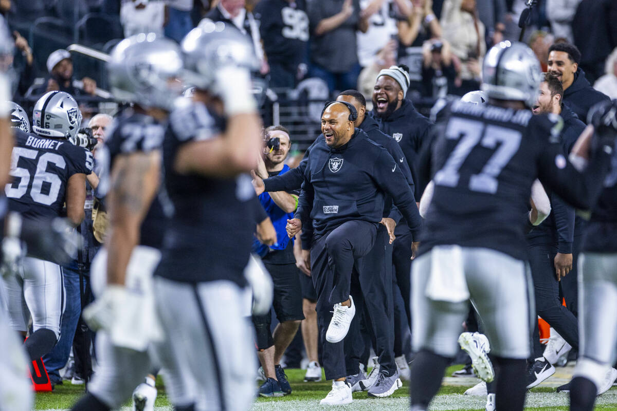 Raiders interim head coach Antonio Pierce and others celebrate a touchdown by defensive tackle ...